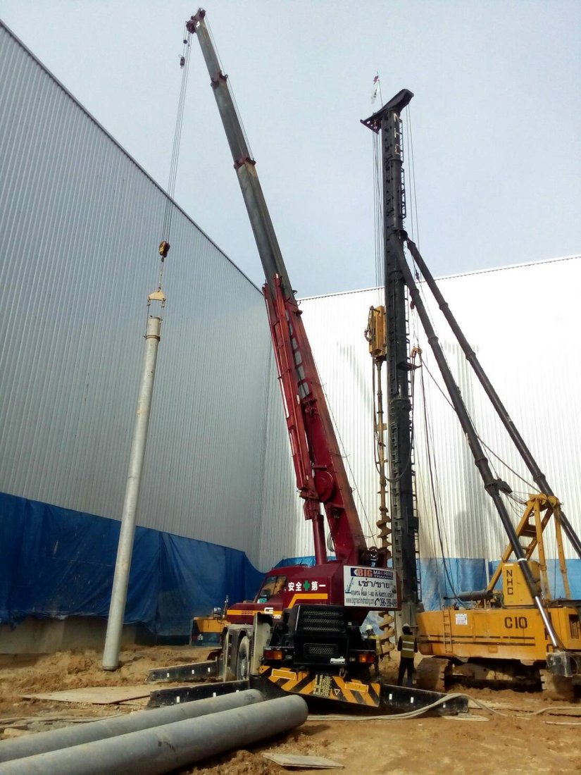 เครนล้อยาง 25 ตัน 4 ล้อ ของ BIG MACHINE TRADING ยกเสาเข็มคอนกรีตสปันเข้าตำแหน่งให้ทีมเจาะเข็ม ที่หน้างานโกดัง KONOIKE Cool Logistics บางพลี