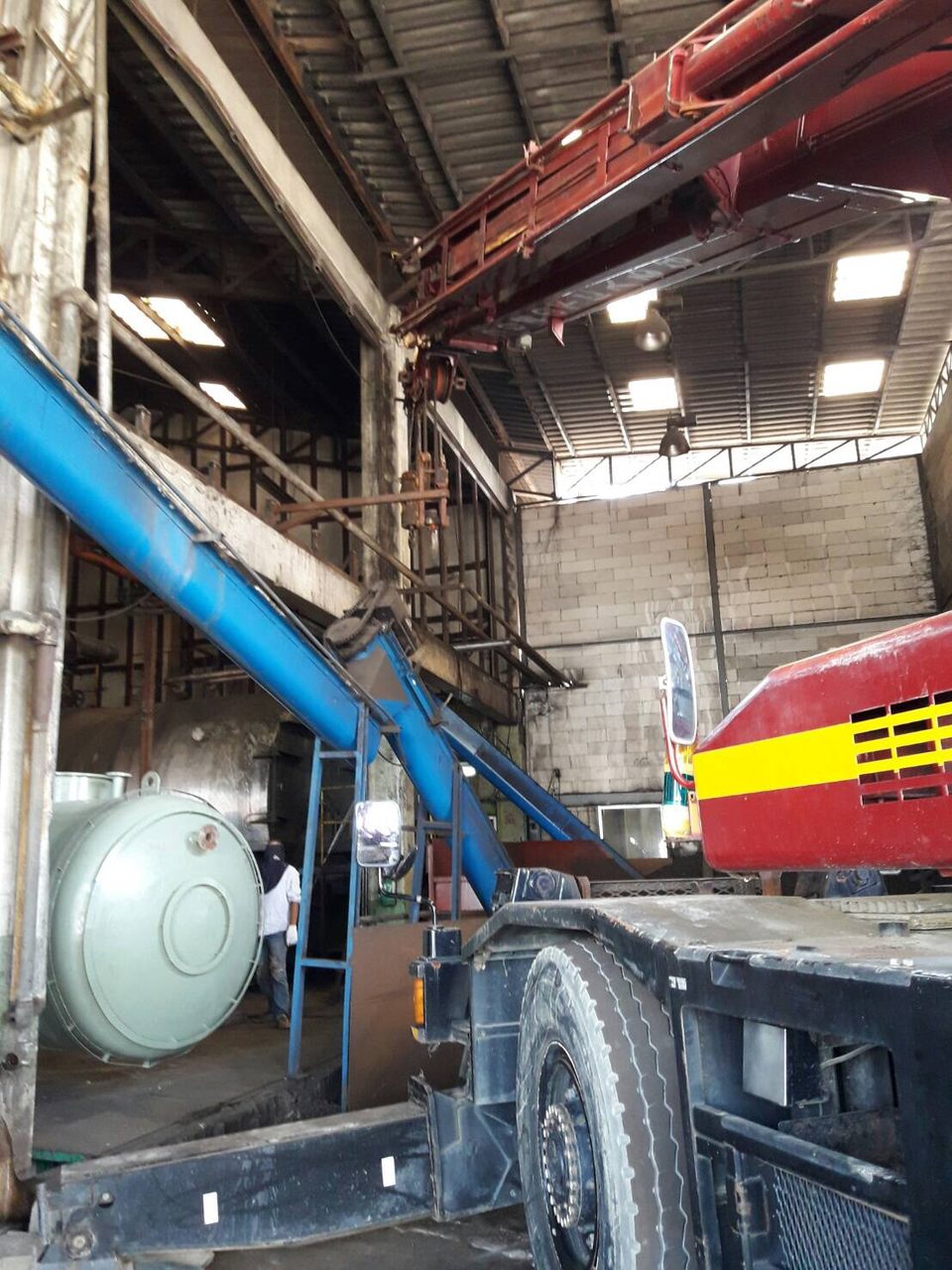เครนของ BIG MACHINE TRADING ทำงานใกล้สายพานลำเลียงภายในโรงงานผลิตหม้อต้มไอน้ำ บริษัท ศุภชัยเจริญทรัพย์ บอยเลอร์